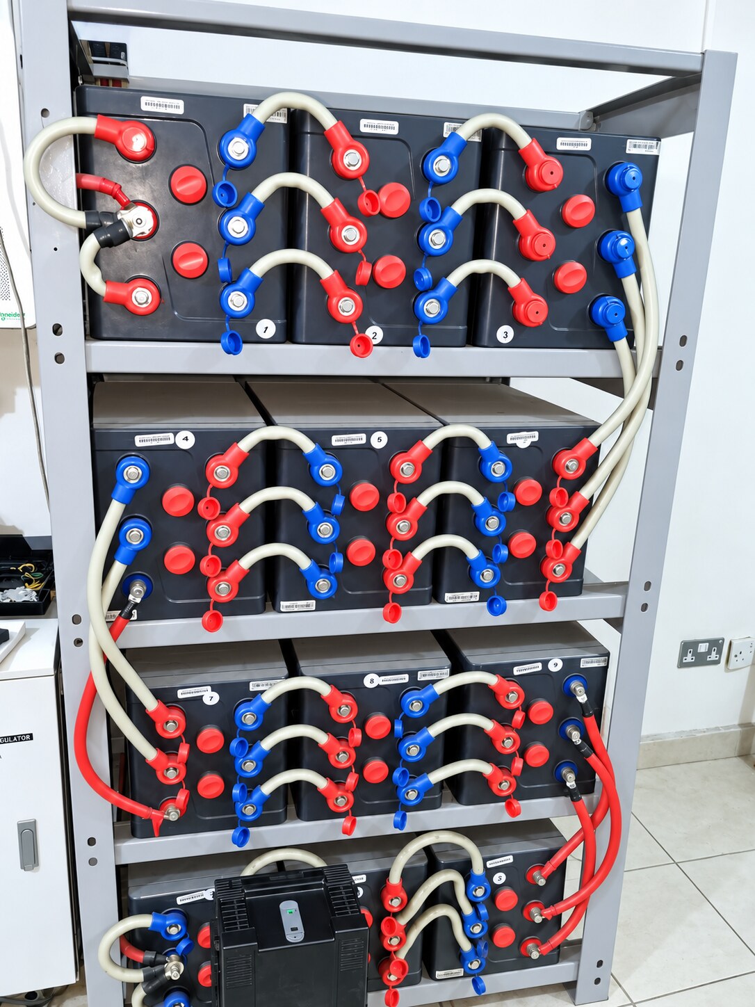Battery bank wired into a steel rack