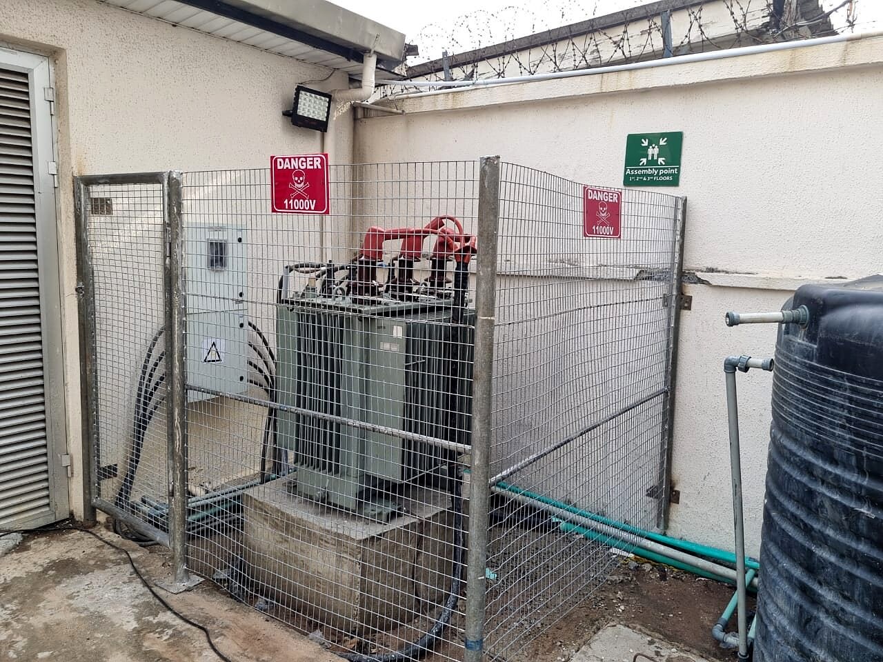 Transformer inside a fenced substation enclosure
